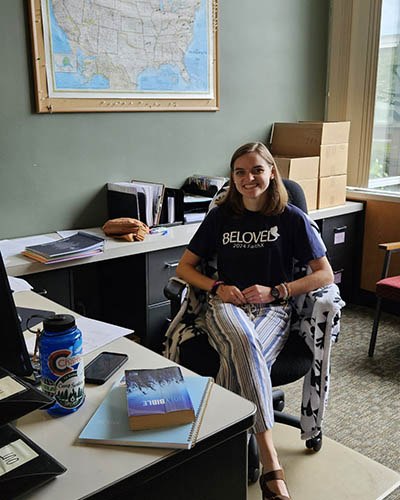 Smiling person sitting in office chair