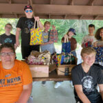 Teens holding bags with supplies