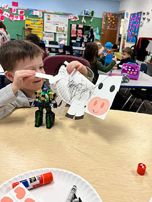 Boy making craft cow