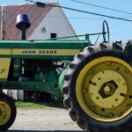 John Deere tractor in front of barn