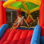 Children bouncing on bouncy slide
