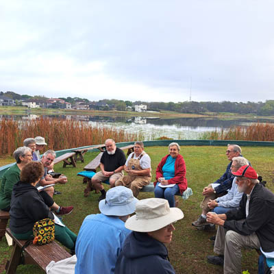 A group of people sitting outdoors