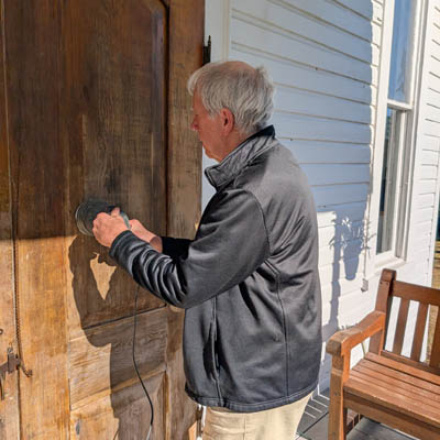 Man sanding a door