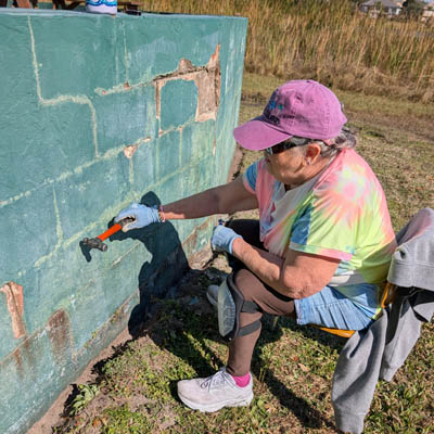 Woman repairing wall
