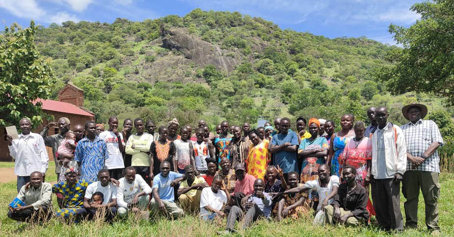 A group of people in front of a mountain
