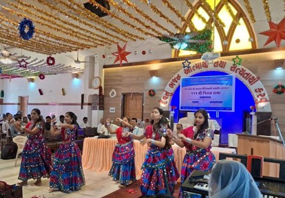 Women in brightly colored dresses dancing in the front of a church