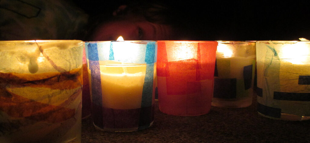 Light shining through colorful candles