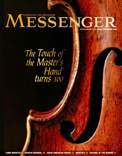 Old violin and words "The Touch of the Master's Hand turns 100"