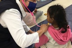 Sister-Norma-plays-doctor-with-a-child-in-CDS-space-courtesy-of-P.-Henry
