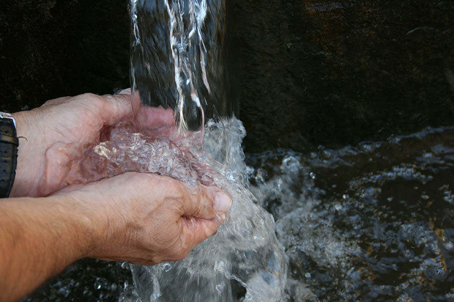 Water pouring into open hands