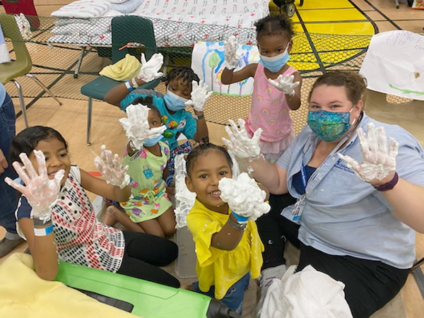 Children's Disaster Services volunteer with children