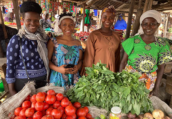 Burundi market with microfinance leader Nadine in green and staff