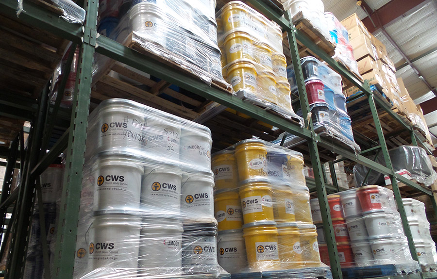 Dozens of CWS buckets wrapped in plastic on warehouse shelves