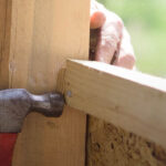 Hammer, nail, and boards with hand