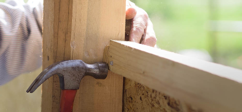 Hammer, nail, and boards with hand