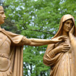 Statues of a Roman centurion and a woman in robes with a sad look