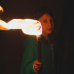 Girl holding torch in the dark